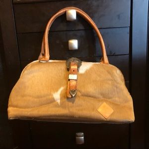 Circle Y cow skin bag with magnetic clasp . A few wear marks .